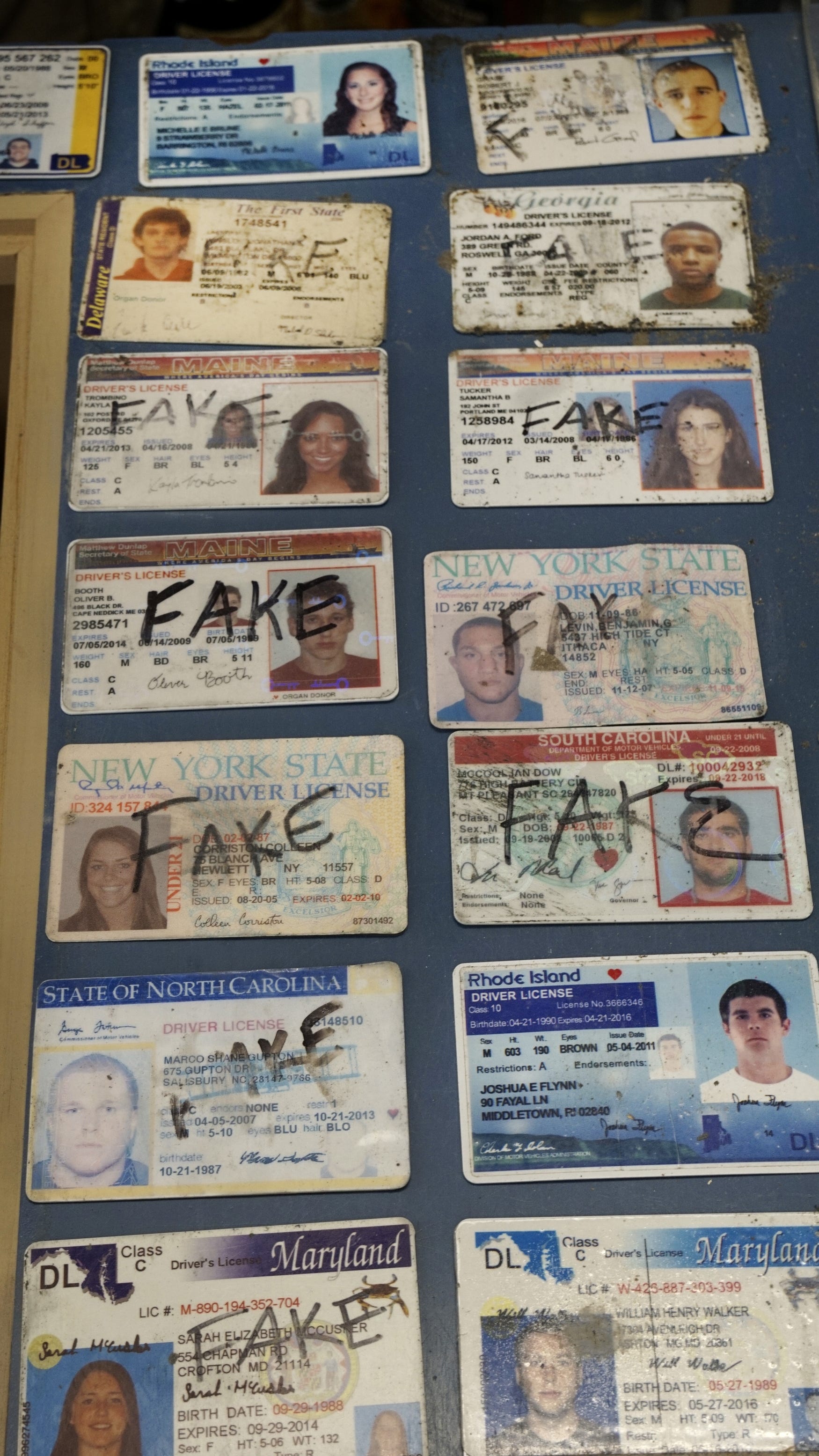 an alcohol server confiscates a fake id